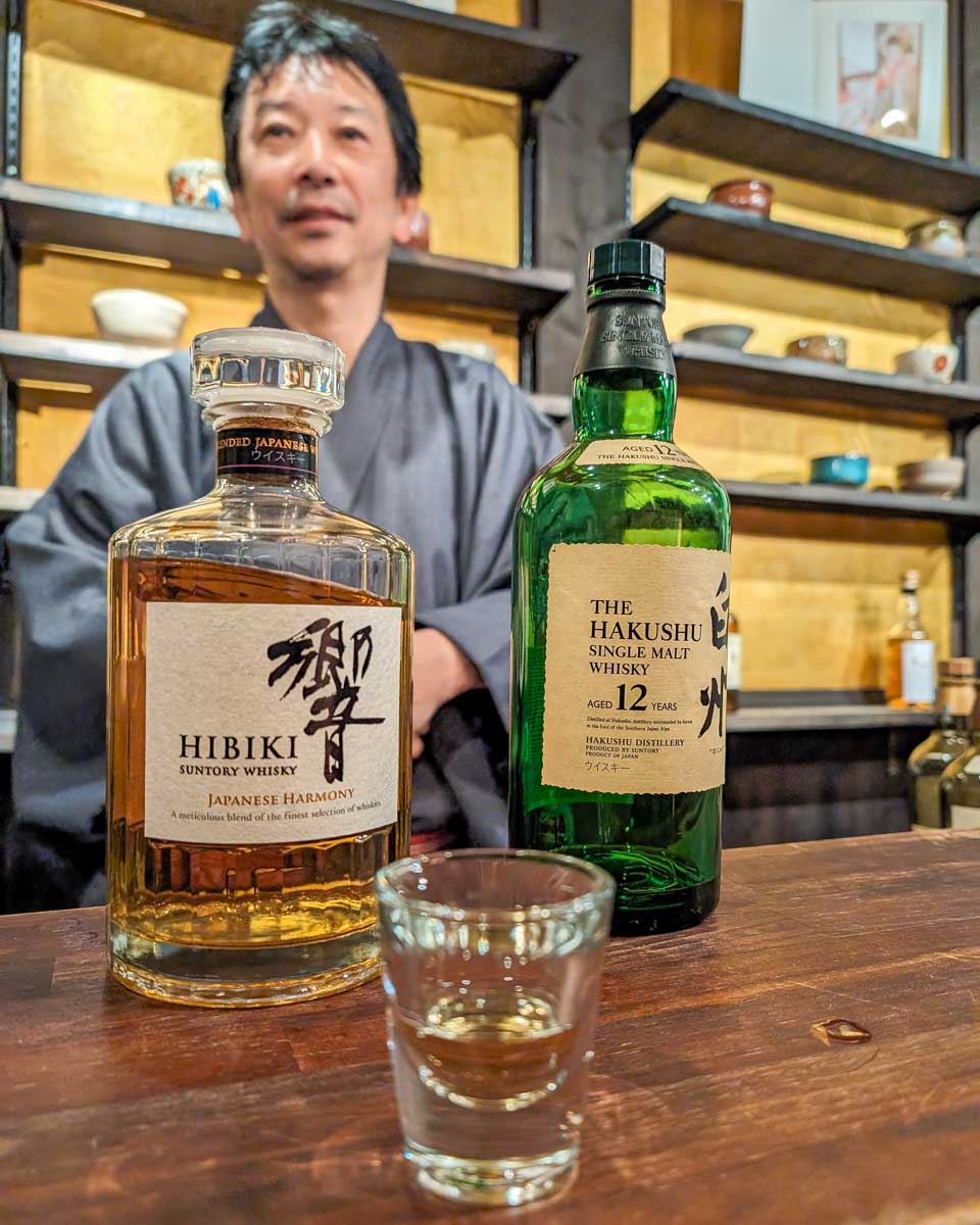 A man serves whisky on a food and drink tour in Tokyo Japan