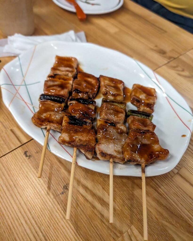 Grilled meat on a stick on a night tour in Tokyo Japan