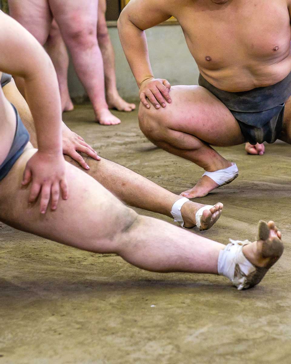 Sumo-wrestlers-stretching-in-Sapporo-Japan