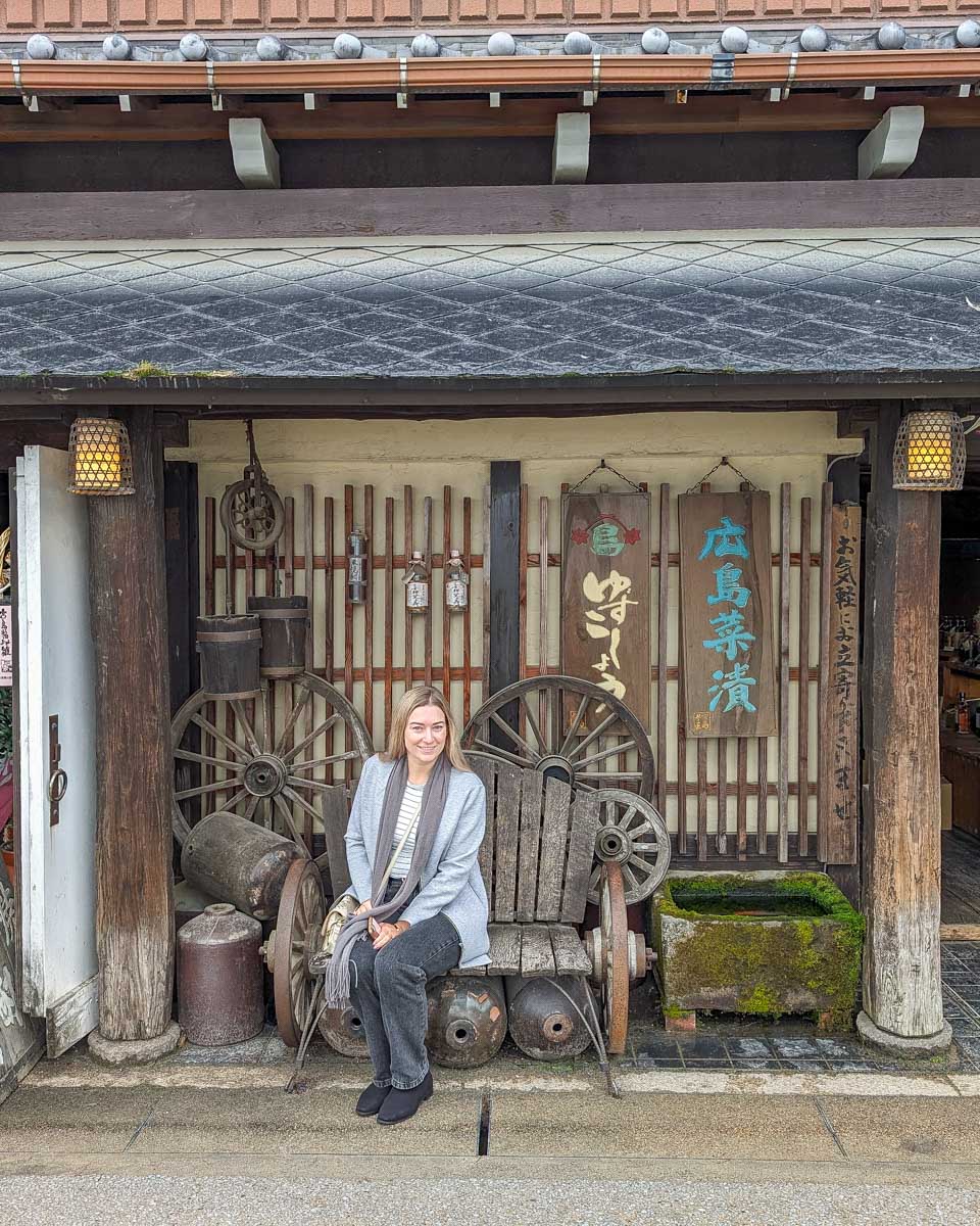 Bailey sits at a sake bar in Miyajima Japan