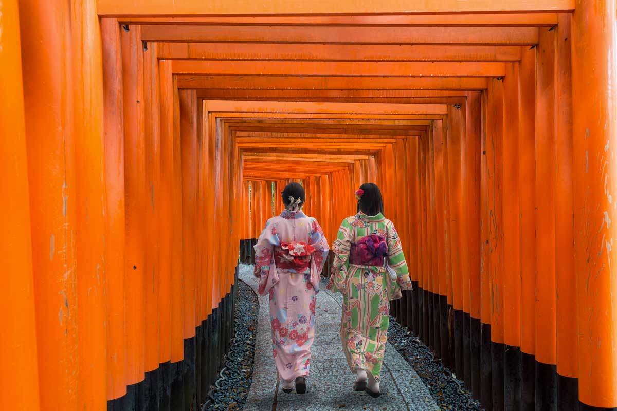 Two geisha walk at the Fushimi Inari in Kyoto Japan