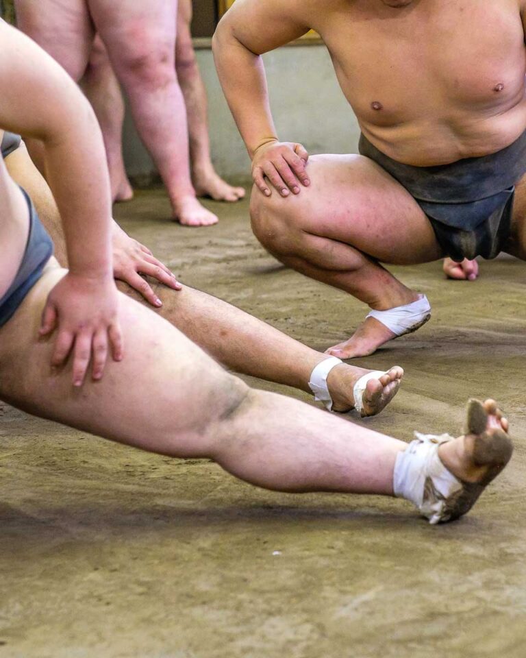 Sumo wrestlers stretching in Tokyo Japan