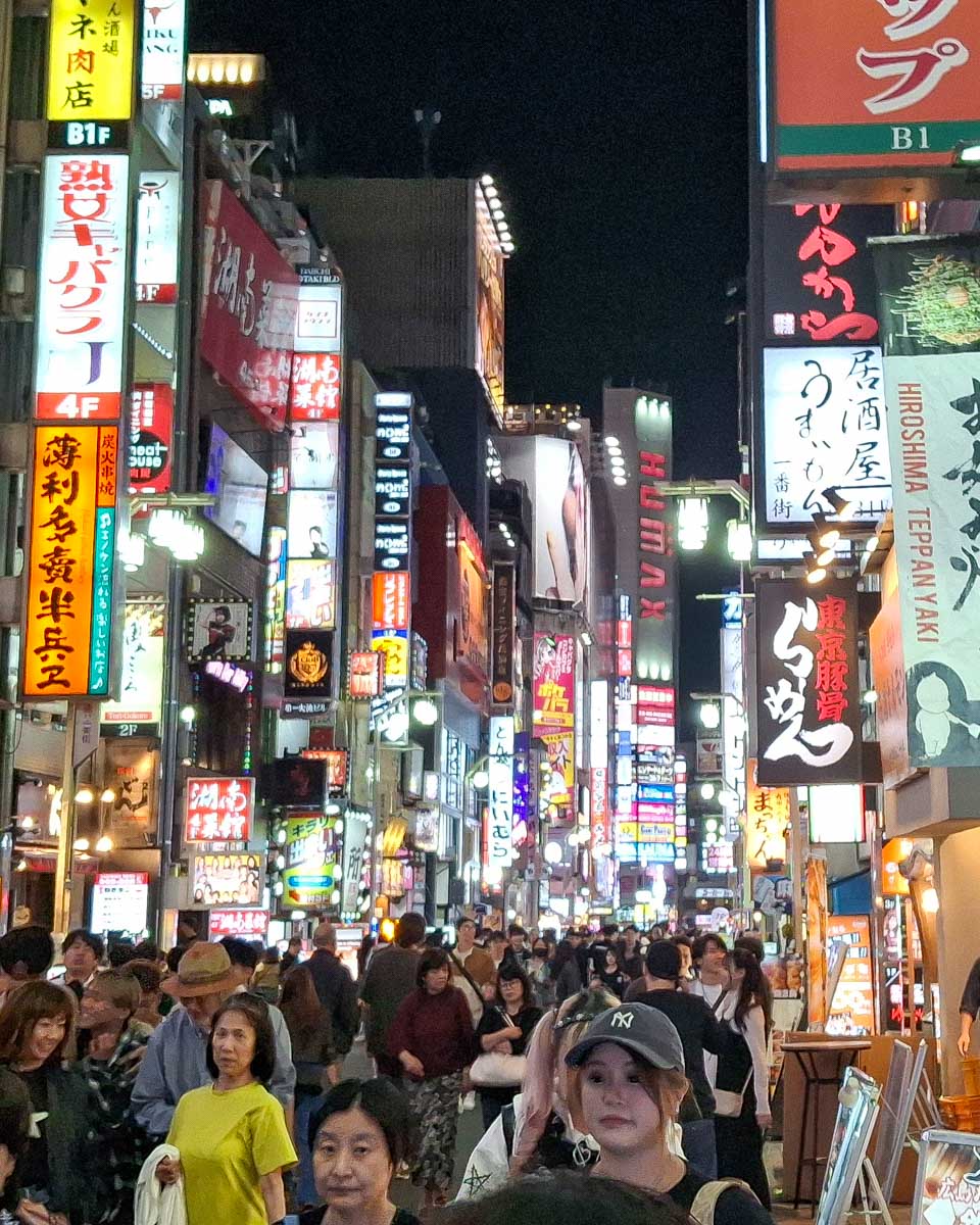 People walk in Shinjuku Tokyo Japan at night