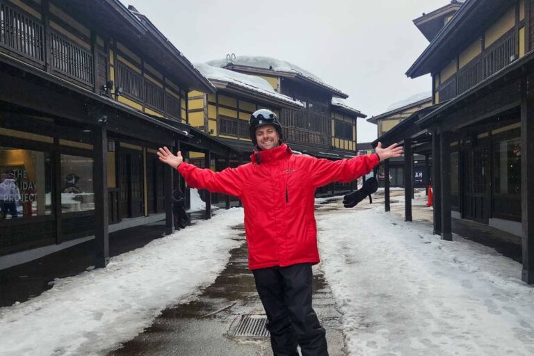 Daniel stands in Niseko Japan in the snow