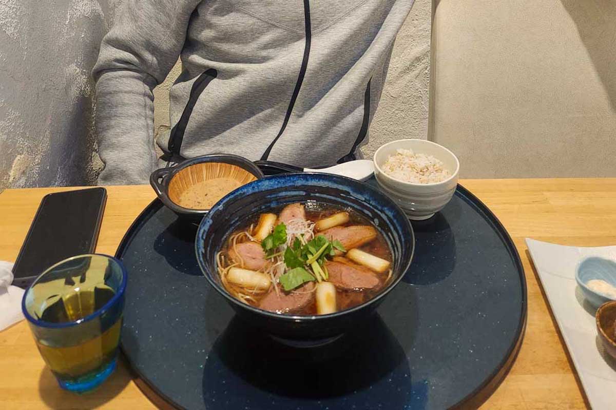 Daniel-smiles-while eating soba noodles in Okinawa Japan
