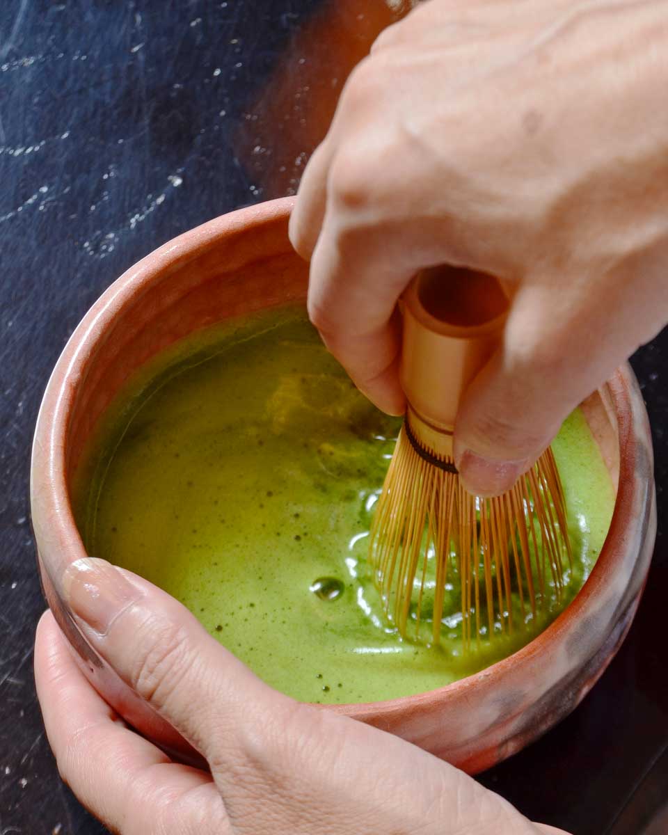 A-person-makes-matcha-during-a-tea-ceremony-in-Asakusa Tokyo Japan