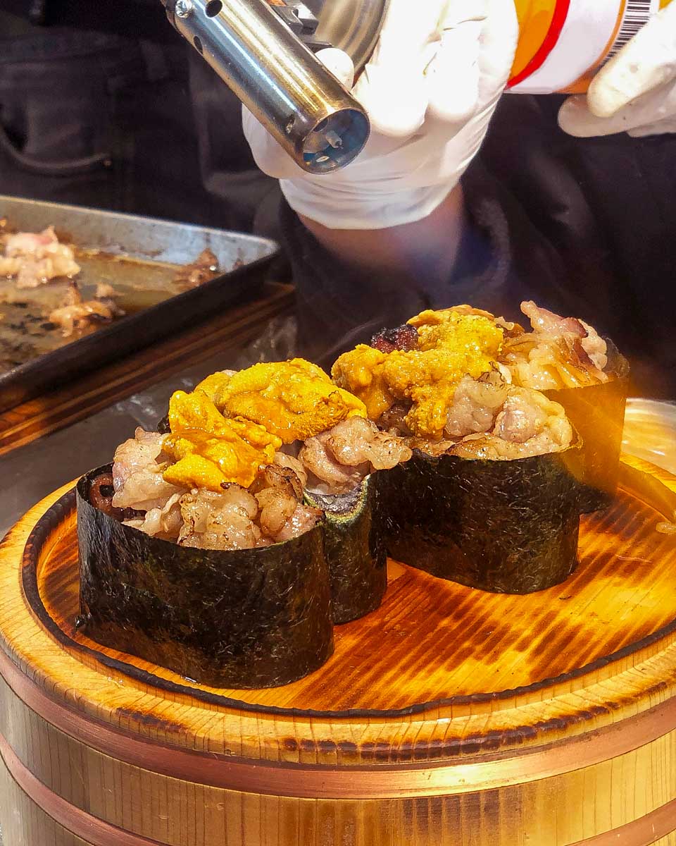 A-person-prepapring-food-at-Tsukiji-Market-near Ginza Tokyo Japan