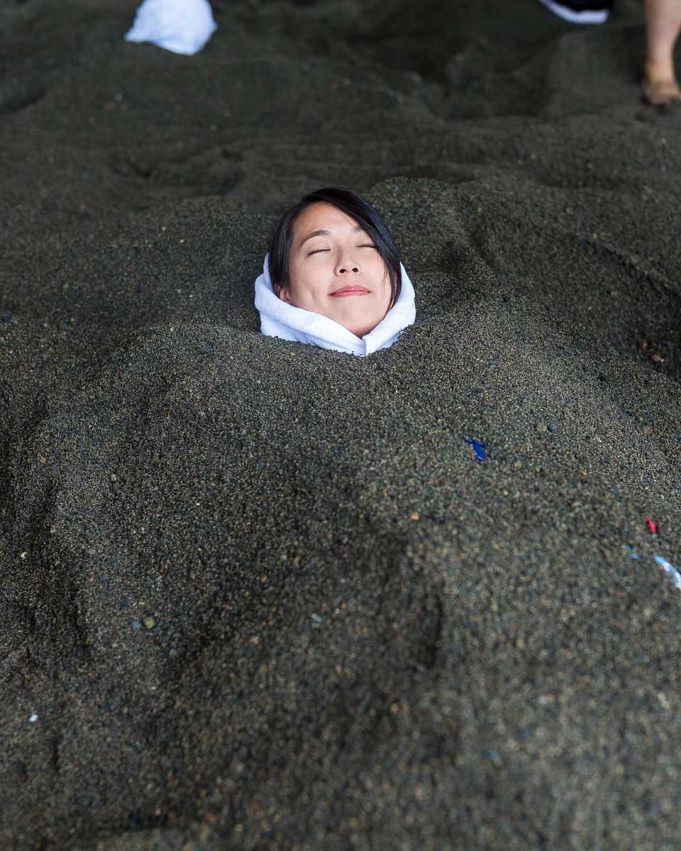 A woman takes a sand bath in Ibusuki Japan
