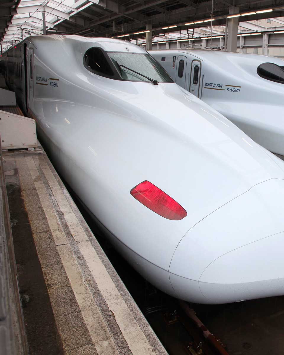 High-speed bullet trains preparing for departure at a station in Japan