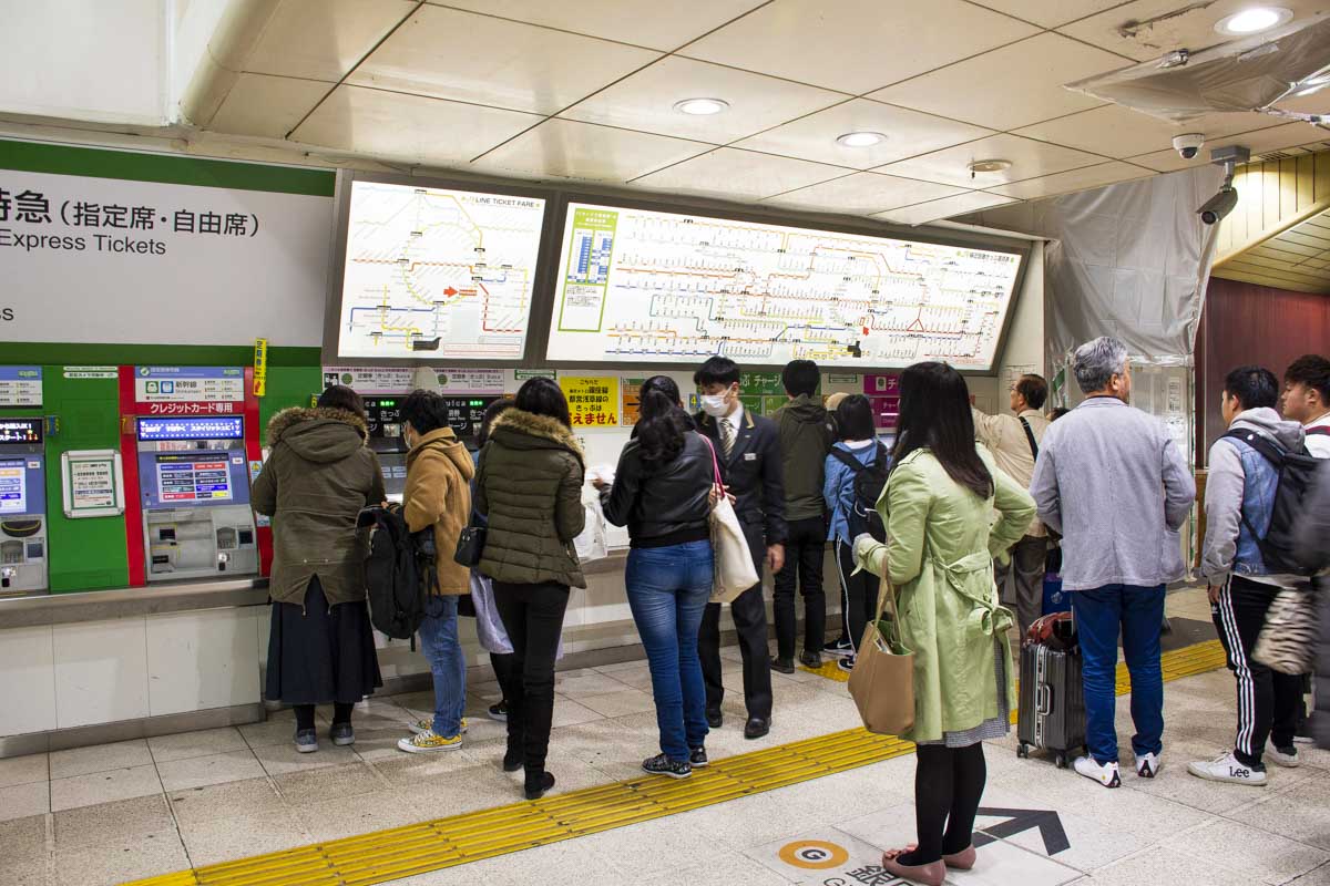 People line up to buy tickets in Japan