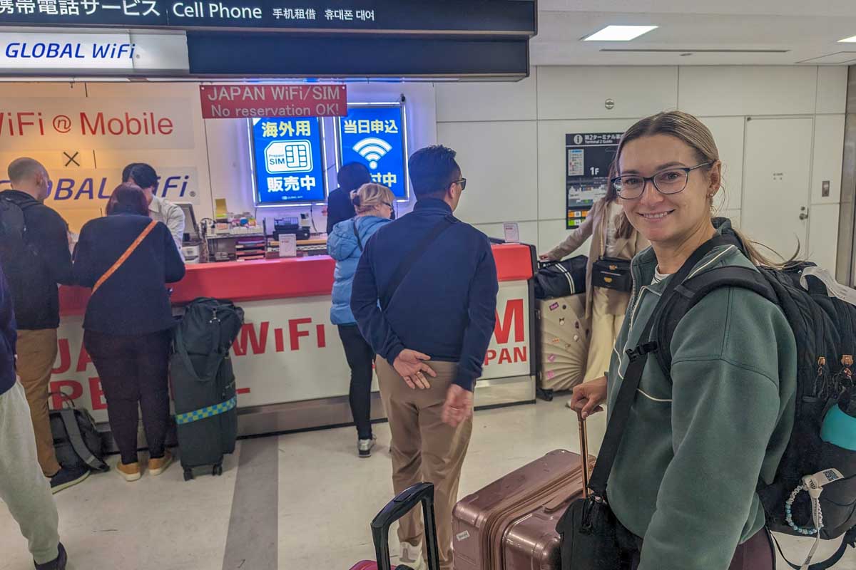 Bailey in line to buy a sim card at the airport in Japan