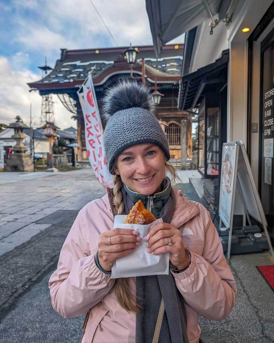 Bailey holds food on the sidewalk in Japan (2)