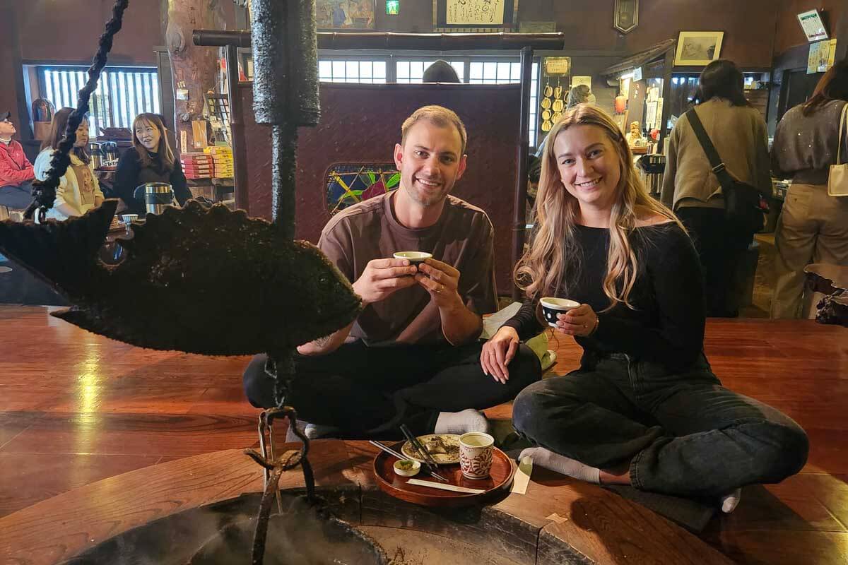 Daniel and Bailey sit with no shoes in Japan