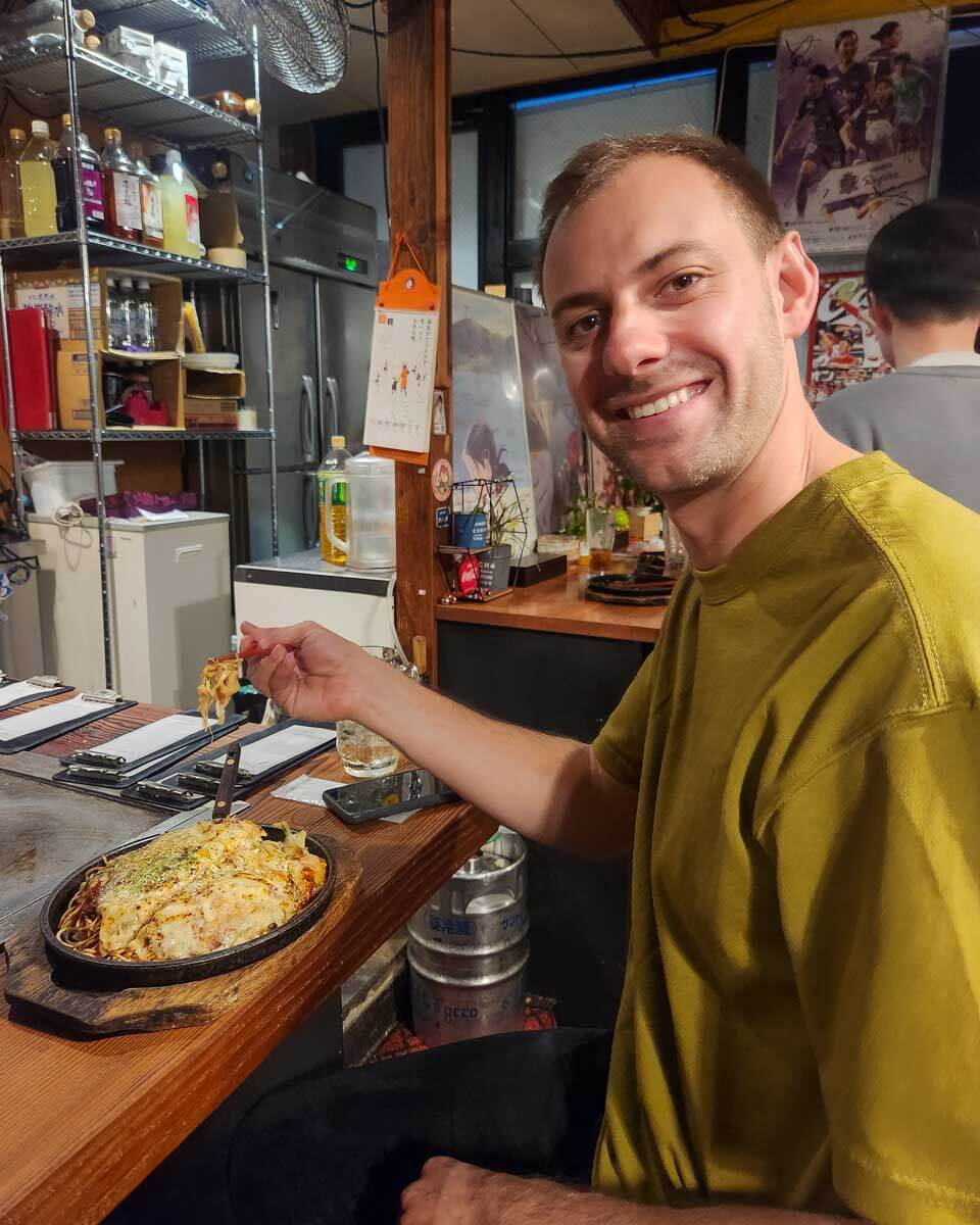 Daniel eats okonomiyaki in Japan
