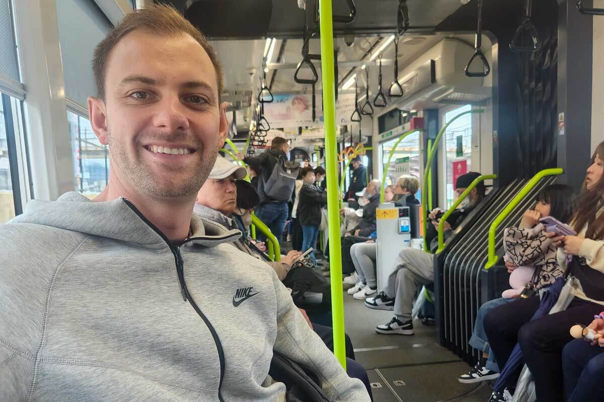 Daniel sits on a train in Japan (1)