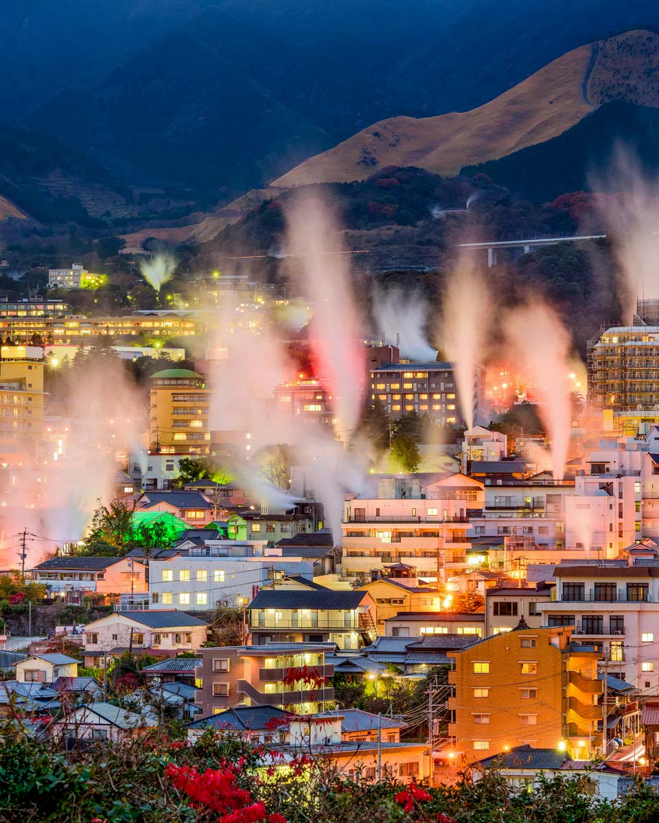 Steam rising from hot springs at night in Beppu Japan (1)