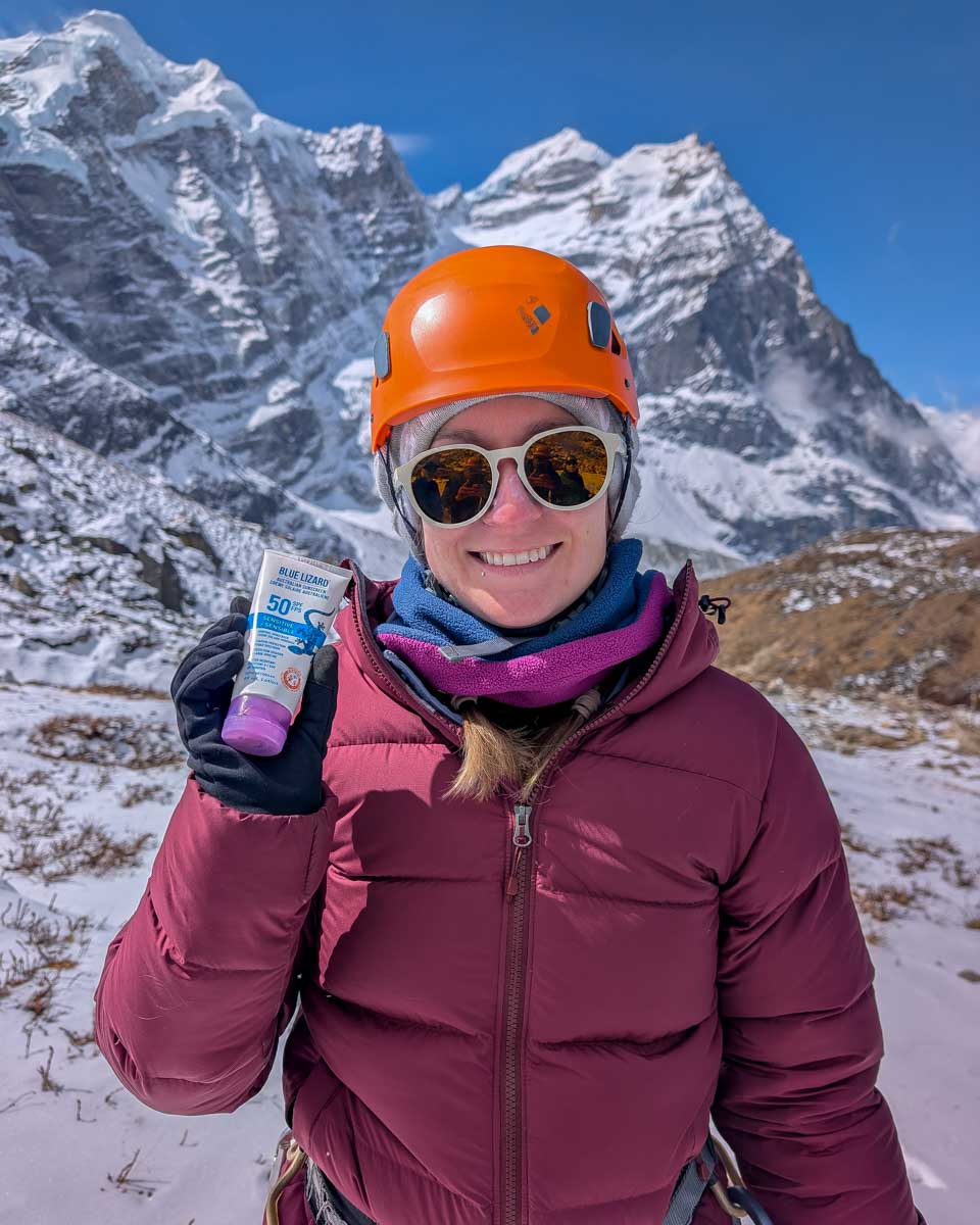 Bailey-holds-Blue-Lizard-sunscreen-with-mountain-in-the-bakground