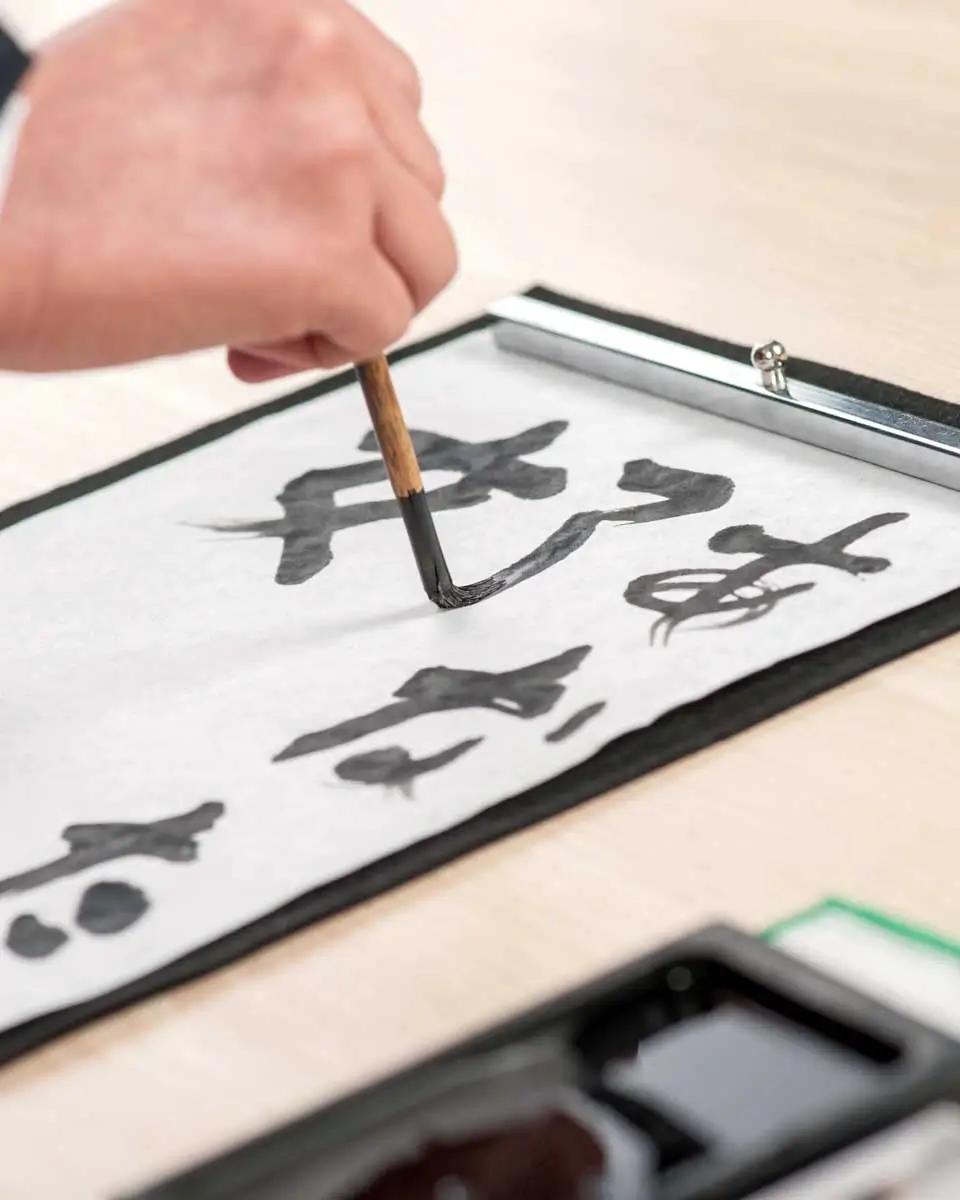 A person writing Japanese calligraphy in Shizuoka, Japan